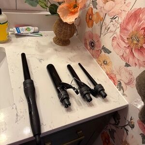 Curling iron ! Comes with multiple size rods .